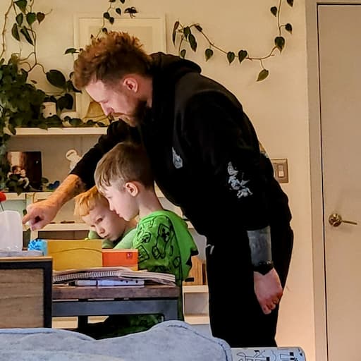 Author: dad@pops Adam pointing at some homework with my 2 kids.